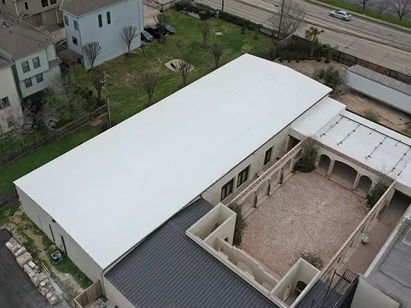 Lone Star Roofing crew working on a commercial flat roof installation in Houston TX